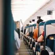 people sitting on blue seats inside an airplane